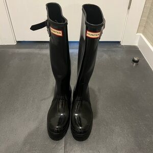 Hunter tall rain boots.